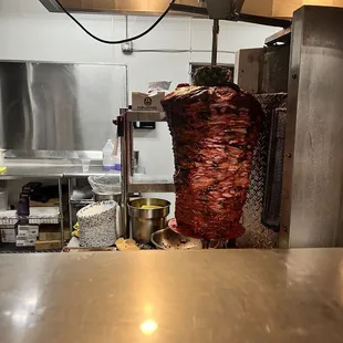 a ham being cooked in a commercial kitchen