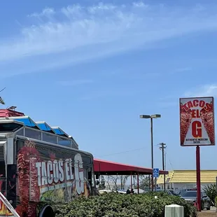 a taco truck parked in front of a restaurant