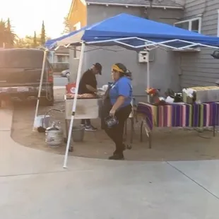 man sitting under a blue tent