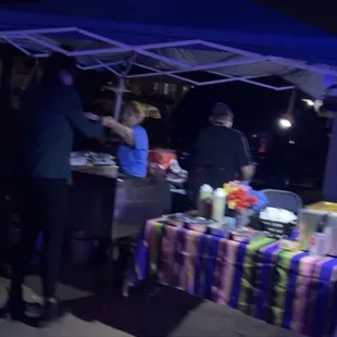 group of people standing under a tent