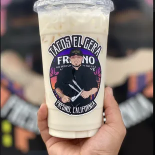 a hand holding a cup of ice cream