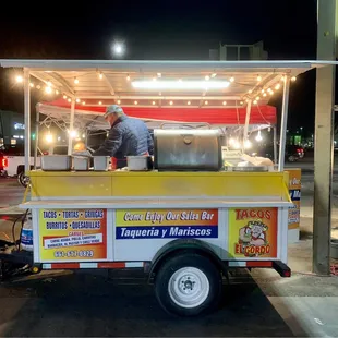 a man preparing food from a cart
