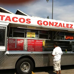 a man standing in front of a food truck