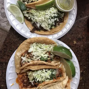 two plates of tacos on a table