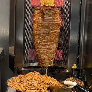 Al pastor meat off the spit