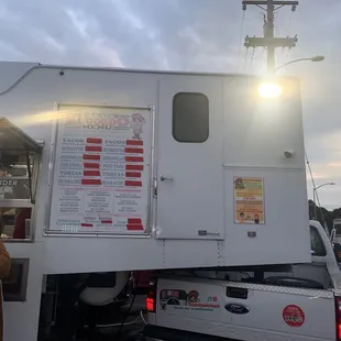 a person standing in front of a food truck