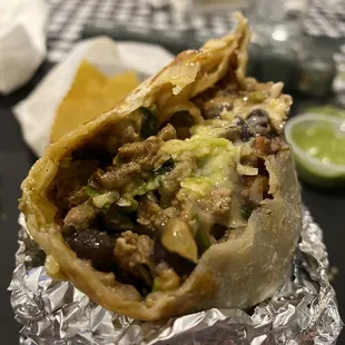 a burrito wrapped in aluminum foil