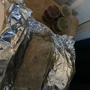a burrito wrapped in aluminum foil