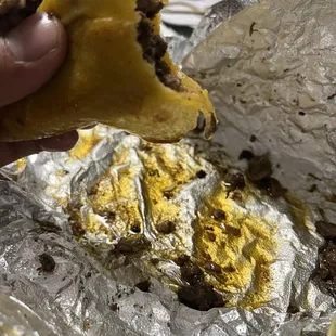 a hand holding a piece of food