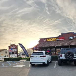 two cars parked in front of a taco&apos;s restaurant