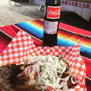 a plate of food and a bottle of coke