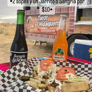 a plate of food and a bottle of soda