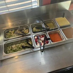 All very mild, the pale sauce in the upper right is a creamy jalapeño sauce that has a slightly nutty flavor.