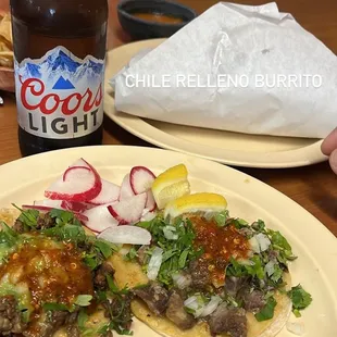 a plate of tacos and a bottle of beer