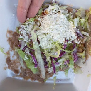 This no meat tostado was $5? Its like 4 bites at most with NO meat? THey could have reduced the price considering im getting no meat??