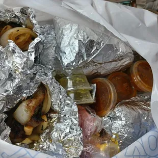  a variety of tacoss wrapped in foil