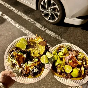 two plates of tacos and a car