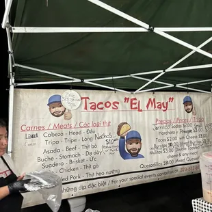 a woman standing under a tent