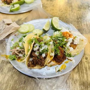 Left to right carnitas , carne asada, Al pastor , fish tacos