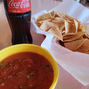 Complementary chips (thick, overcooked) and salsa (flavorful, fresh)