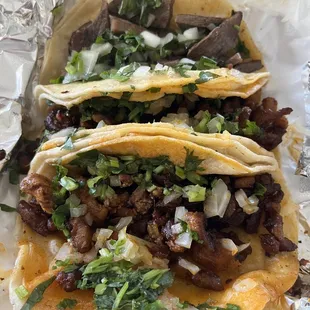 2 Tacos al pastor and 1 lengua taco.