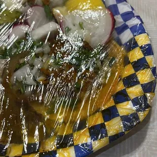 a plate of food wrapped in plastic