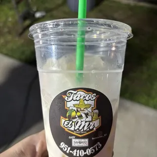 a hand holding a drink