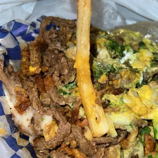 a hand holding a piece of food