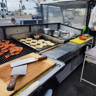 a man cooking food on a grill