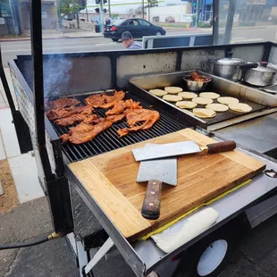 a grill with food cooking on it