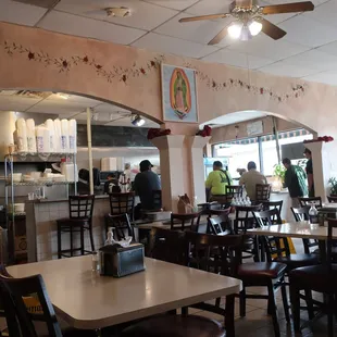 Bar seating and open kitchen in the background.