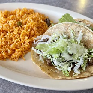 Two carne asada tacos and rice