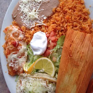 Combo plate with tamal, chicken taco, and cheese enchilada.