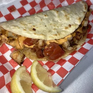 Homemade tortilla shrimp taco with orange chipotle like sauce