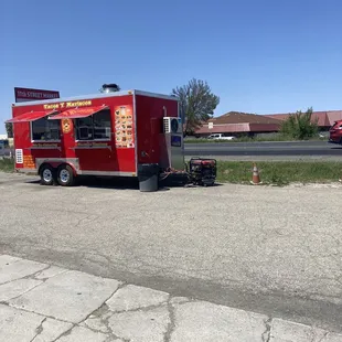 a taco truck parked on the side of the road