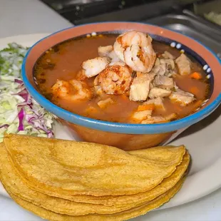 a bowl of soup and tortillas