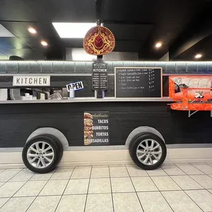 The cute food truck in the interior with the salsa bar.