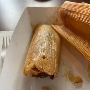 a plate of tamales and a fork