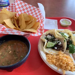 Carne asada taco combo with rice and beans. Squeeze some fresh lime, add their salsa verde. Mmm good.
