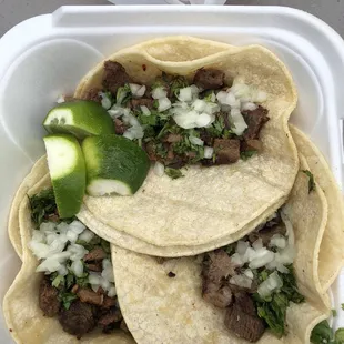 three tacoss in a styrofoam container
