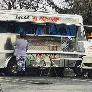 a man standing in front of a food truck