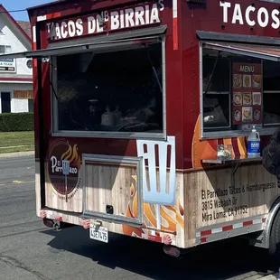 a man standing in front of a taco truck