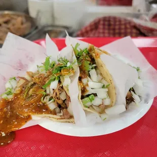 a plate of tacos on a red tray