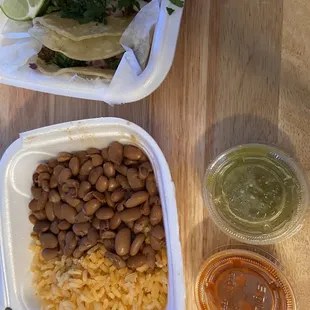 Side of rice and beans with hot and mild sauce