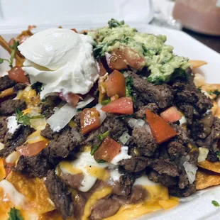 Nachos with asada guac and sour cream