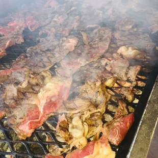 meat being cooked on a grill