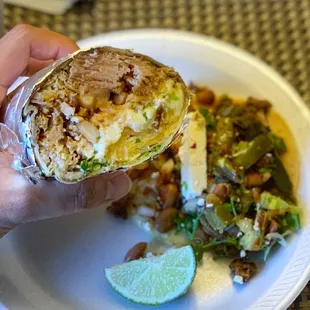 Carnitas burrito and taco on the plate.