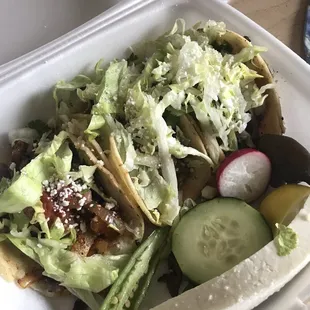 2 steak tacos on the right with cheese and sour cream and then one on the left was al pastor. With hot sauce, not mild.