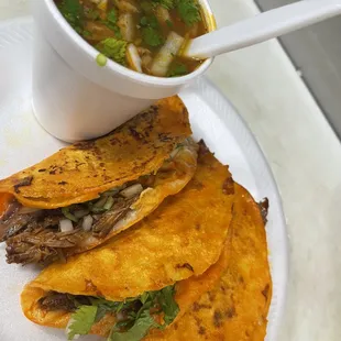 a bowl of soup and a plate of tortillas