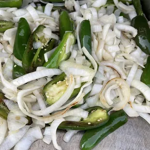 a pile of onions and jalapenos